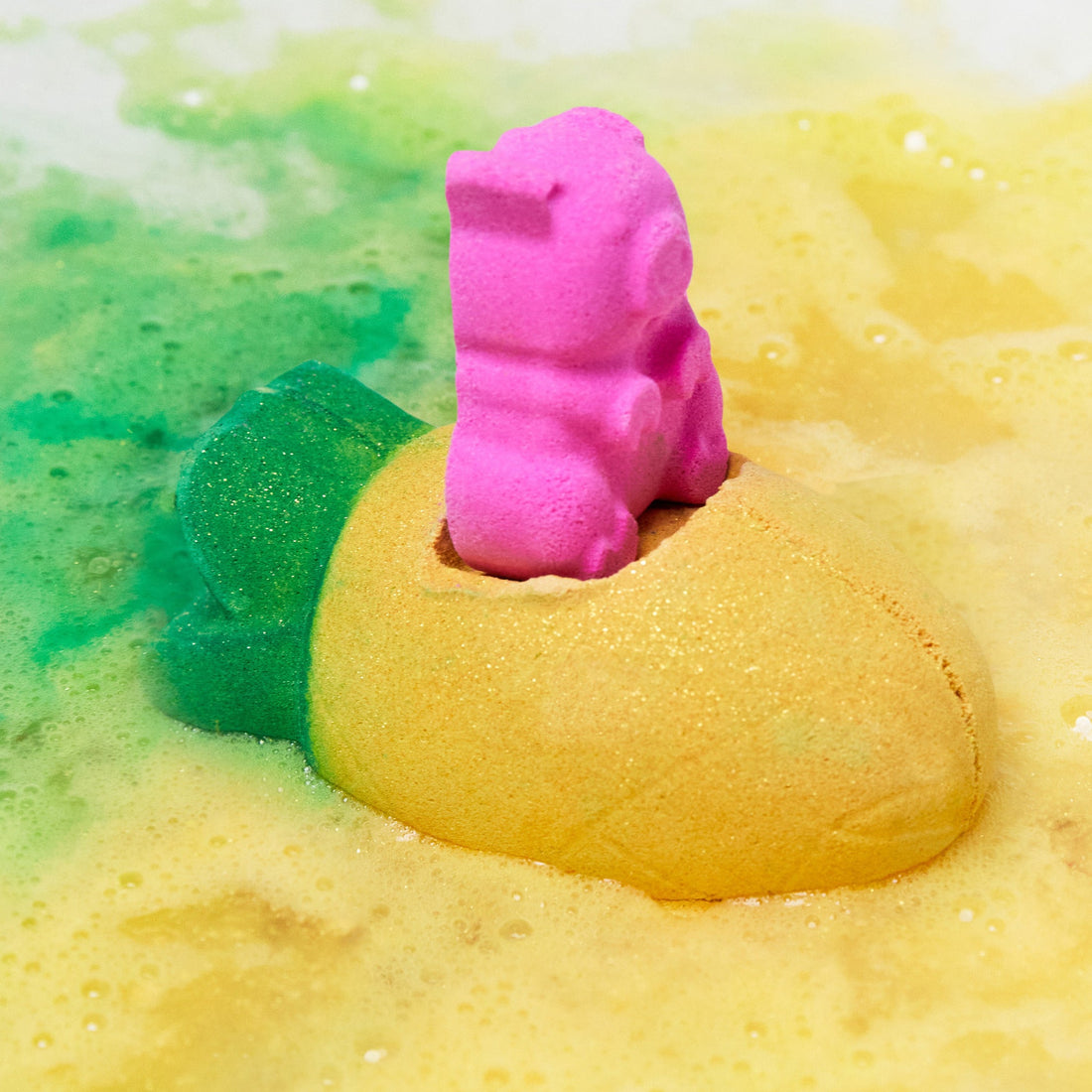 The Pig In A Poke bath bomb has dissolved leaving behind fresh, golden bath water laced with thin, velvety foam and a flash of pink in the centre.