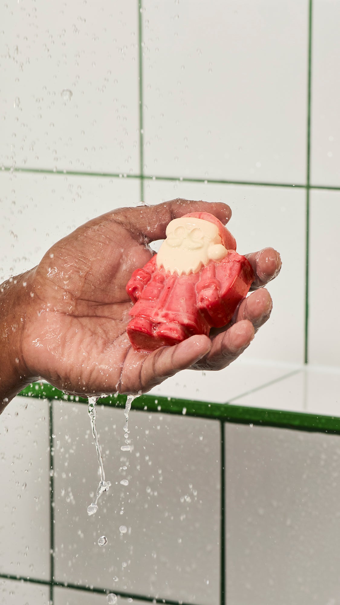 Hand holding wet red and cream Everyone&