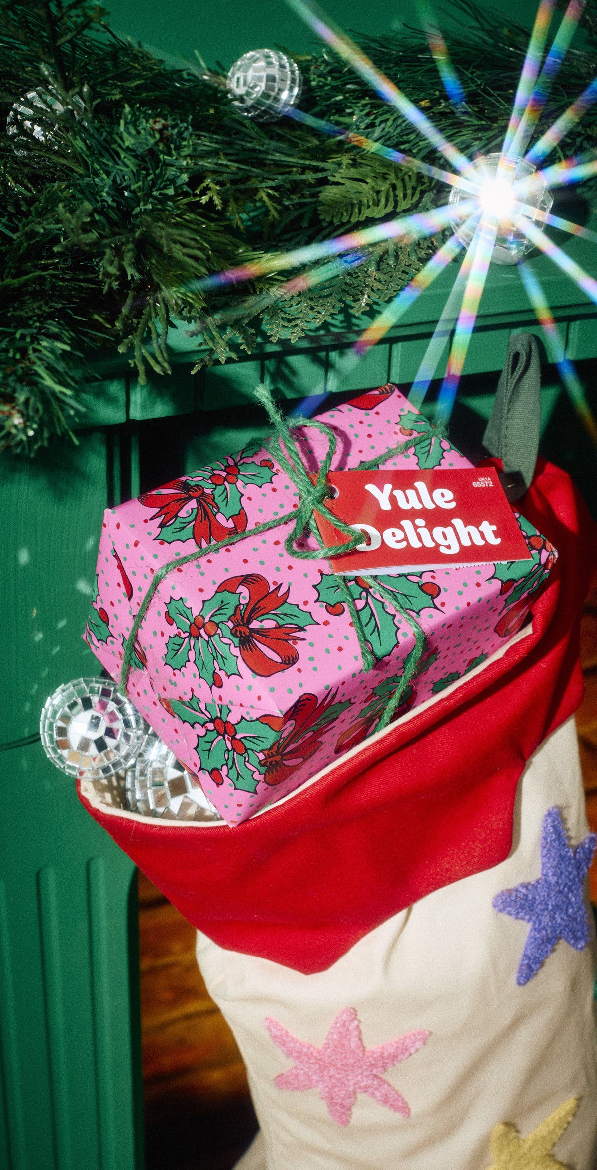 Yule Delight gift in pink festive wrapping tucked into a Christmas stocking.