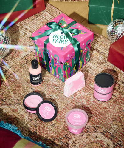 Glow Fairy gift box displayed with pink bath and body products beneath a Christmas tree.