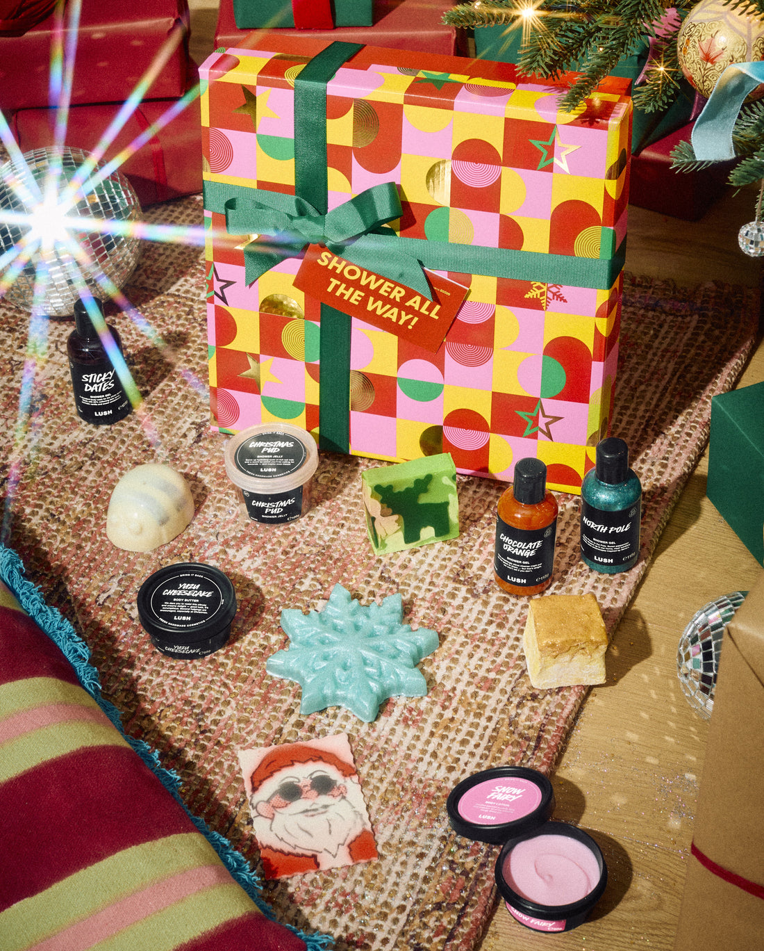 Shower All the Way! gift box displayed with bottles, pots and colourful solid bath and body products.