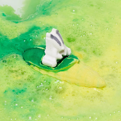 The Beat The Clock Badger bath bomb has fully dissolved leaving behind a thick blanket of lemon-lime, vibrant yellow and green foam.