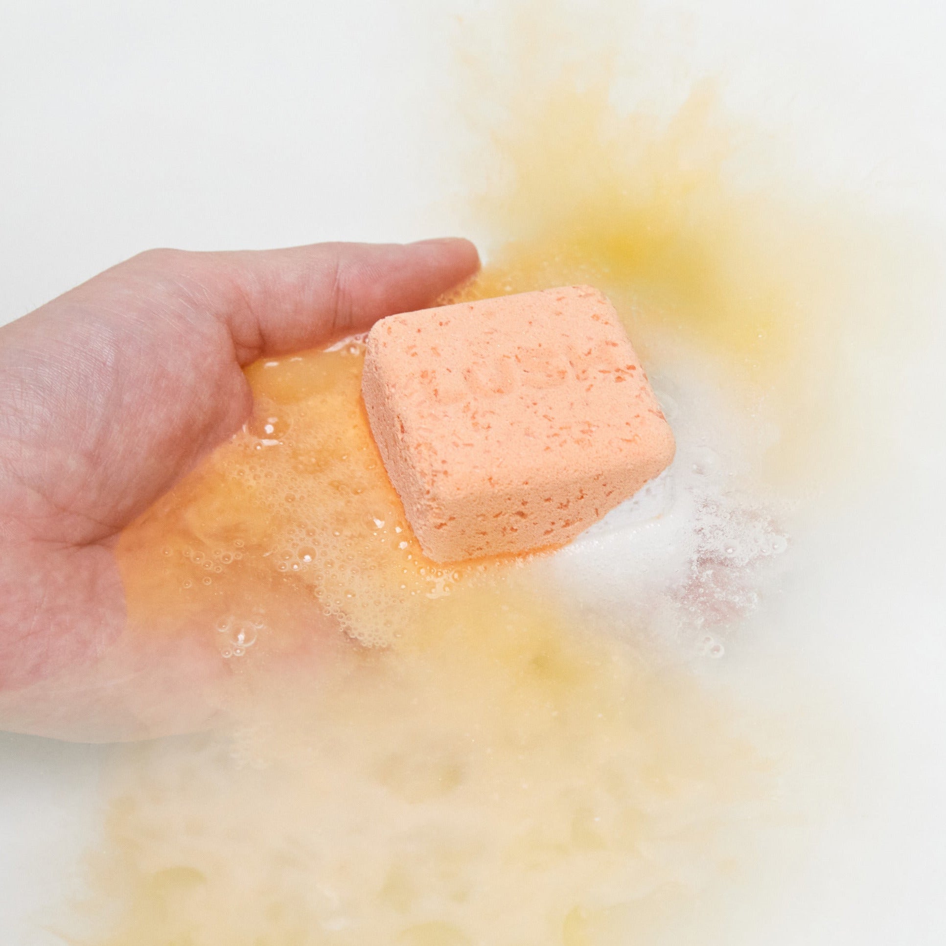 The Cold Water Soother bath bomb has fully dissolved leaving behind dreamy, golden-yellow waters.