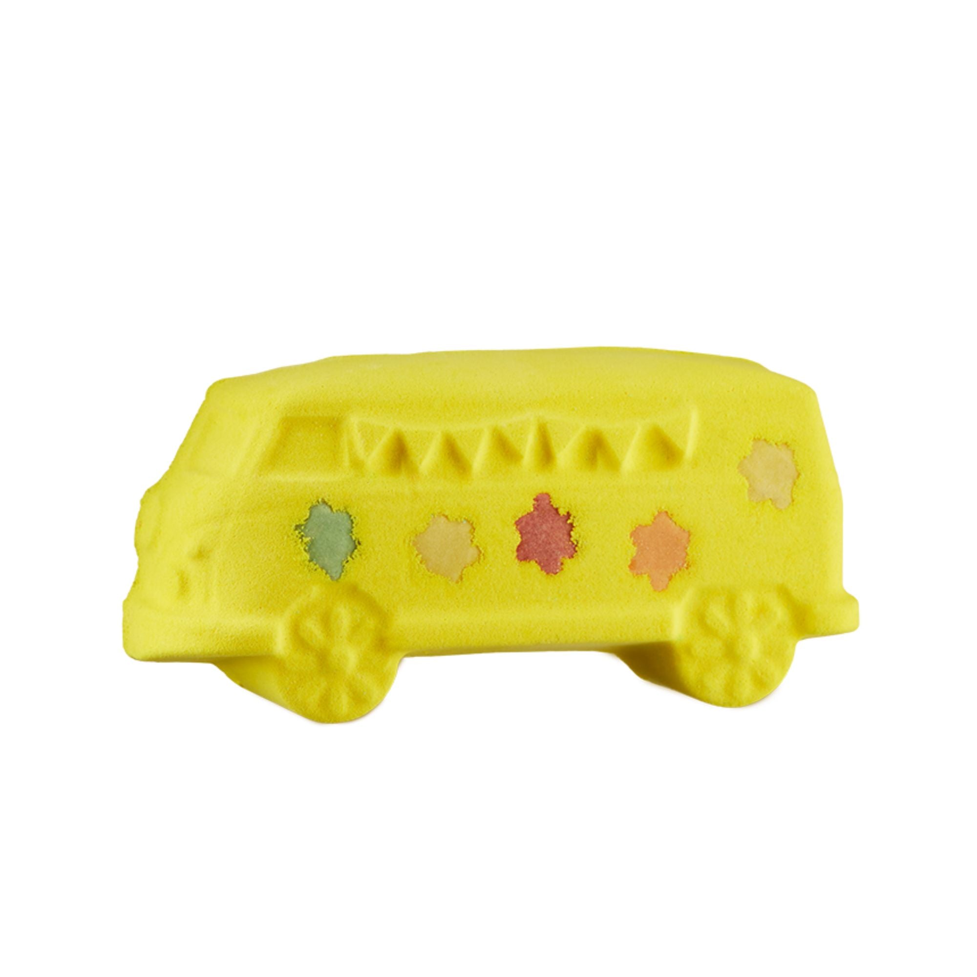 Magic Bus. A fun, vibrant yellow bath bomb shaped like a classic long school bus complete with flower wheels and five coloured flower details on the side.