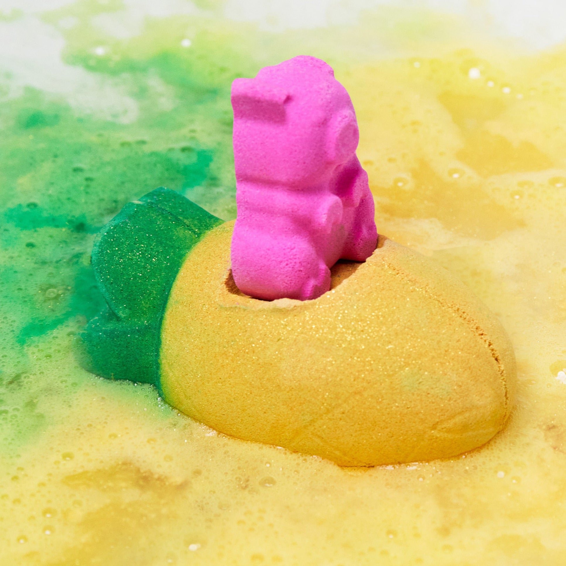 The Pig In A Poke bath bomb has dissolved leaving behind fresh, golden bath water laced with thin, velvety foam and a flash of pink in the centre.