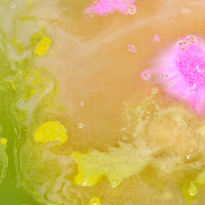 The Pig In A Poke bath bomb has dissolved leaving behind fresh, golden bath water laced with thin, velvety foam and a flash of pink in the centre.