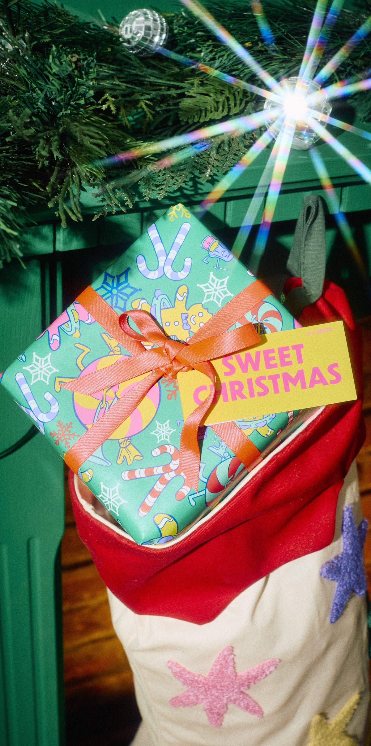 Sweet Christmas wrapped gift with an orange bow tucked into a Christmas stocking.