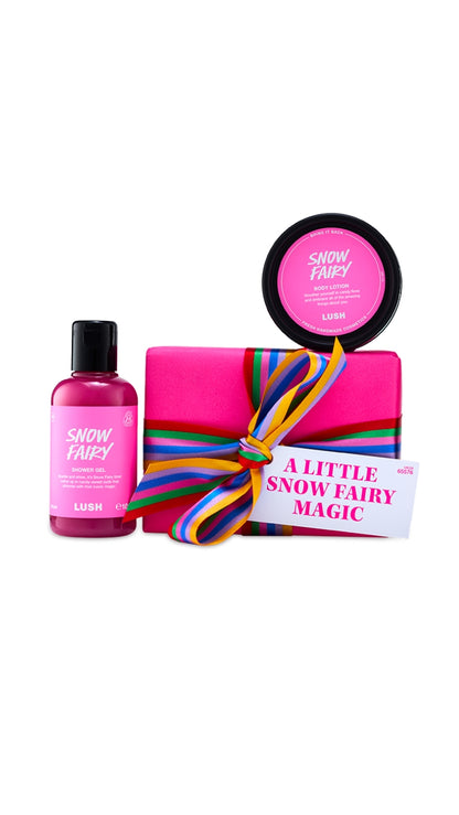 A Little Snow Fairy Magic gift set featuring Snow Fairy shower gel and body lotion displayed around a pink wrapped box. 