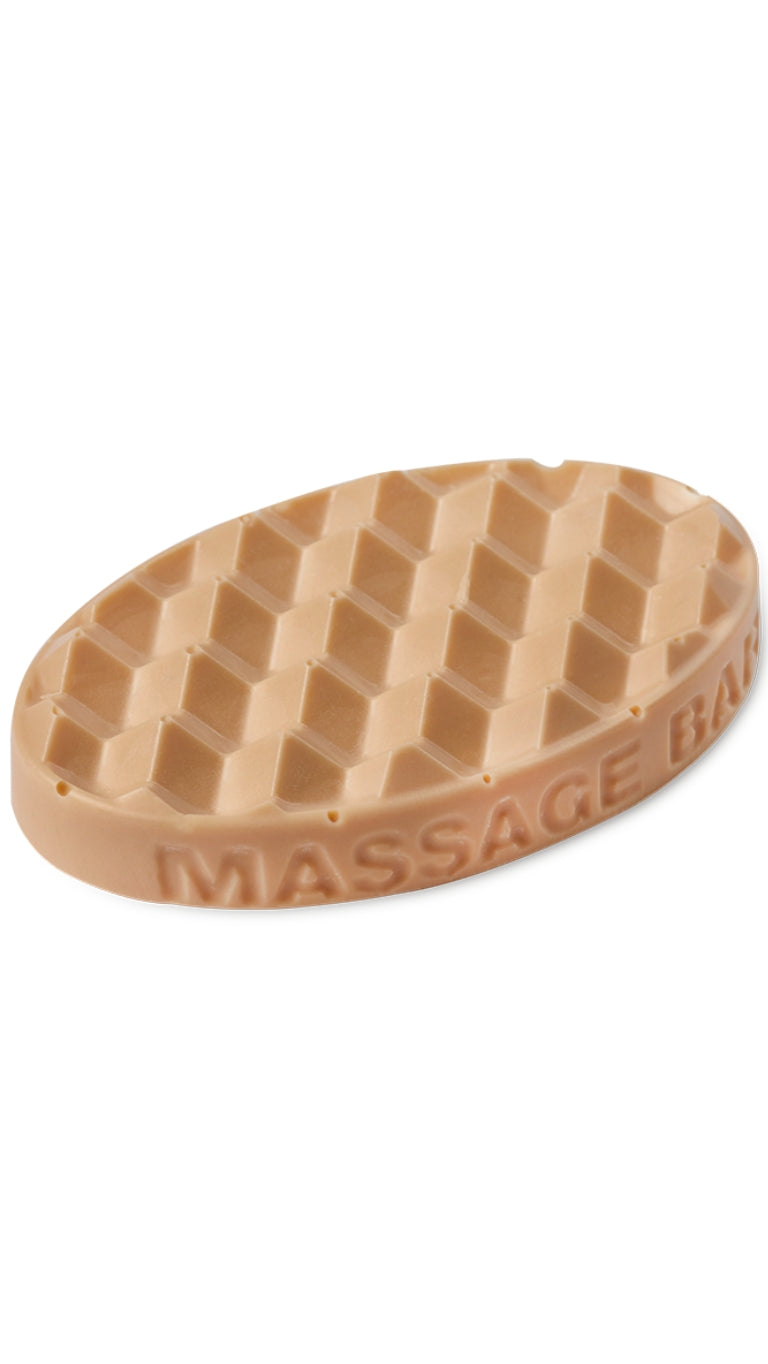 A clay coloured oval-shaped lush massage bar that smells zesty. 