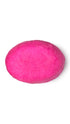 A pink oval-shaped lush conditioner bar that smells like strawberries.