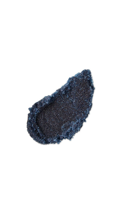 A black tear-shaped swatch of a lush lip scrub. 