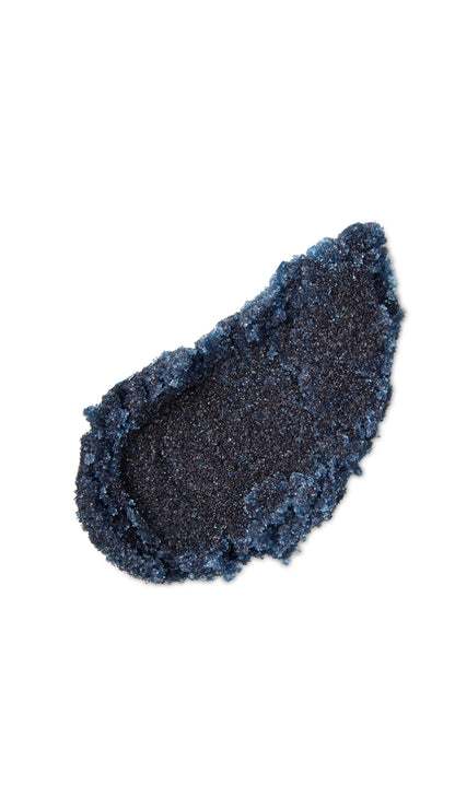 A black tear-shaped swatch of a lush lip scrub. 