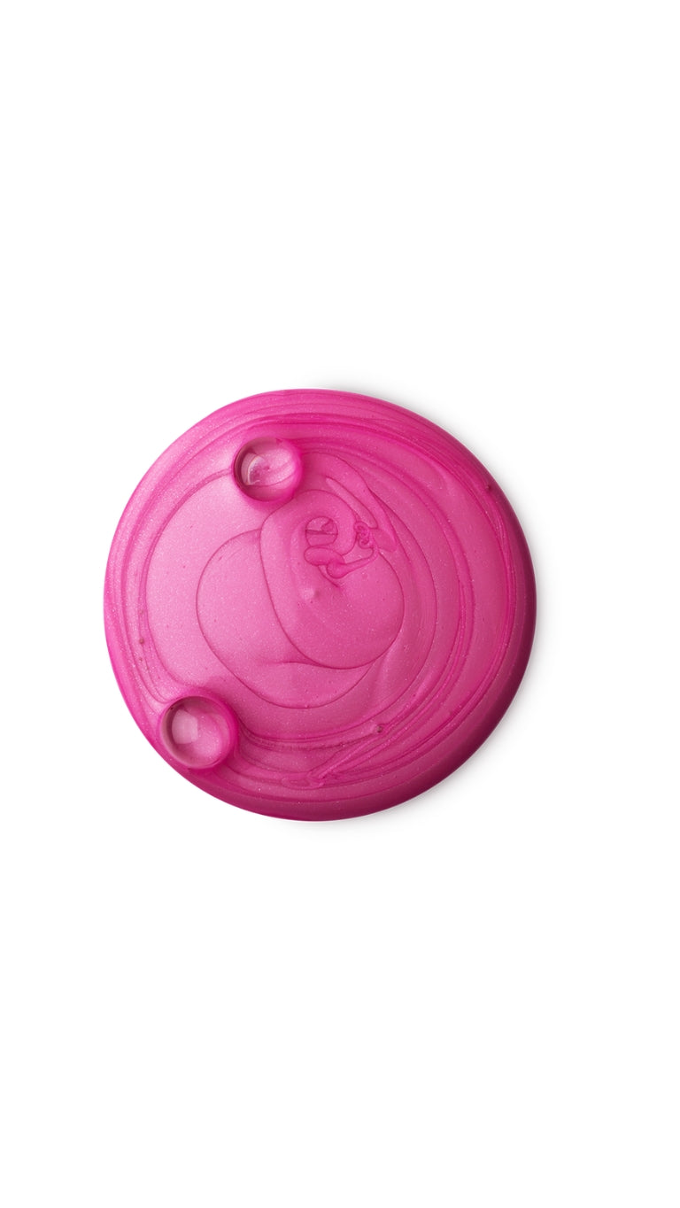 A pink circular swatch of a lush shower gel. 