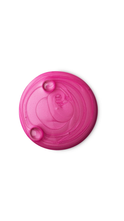 A pink circular swatch of a lush shower gel. 