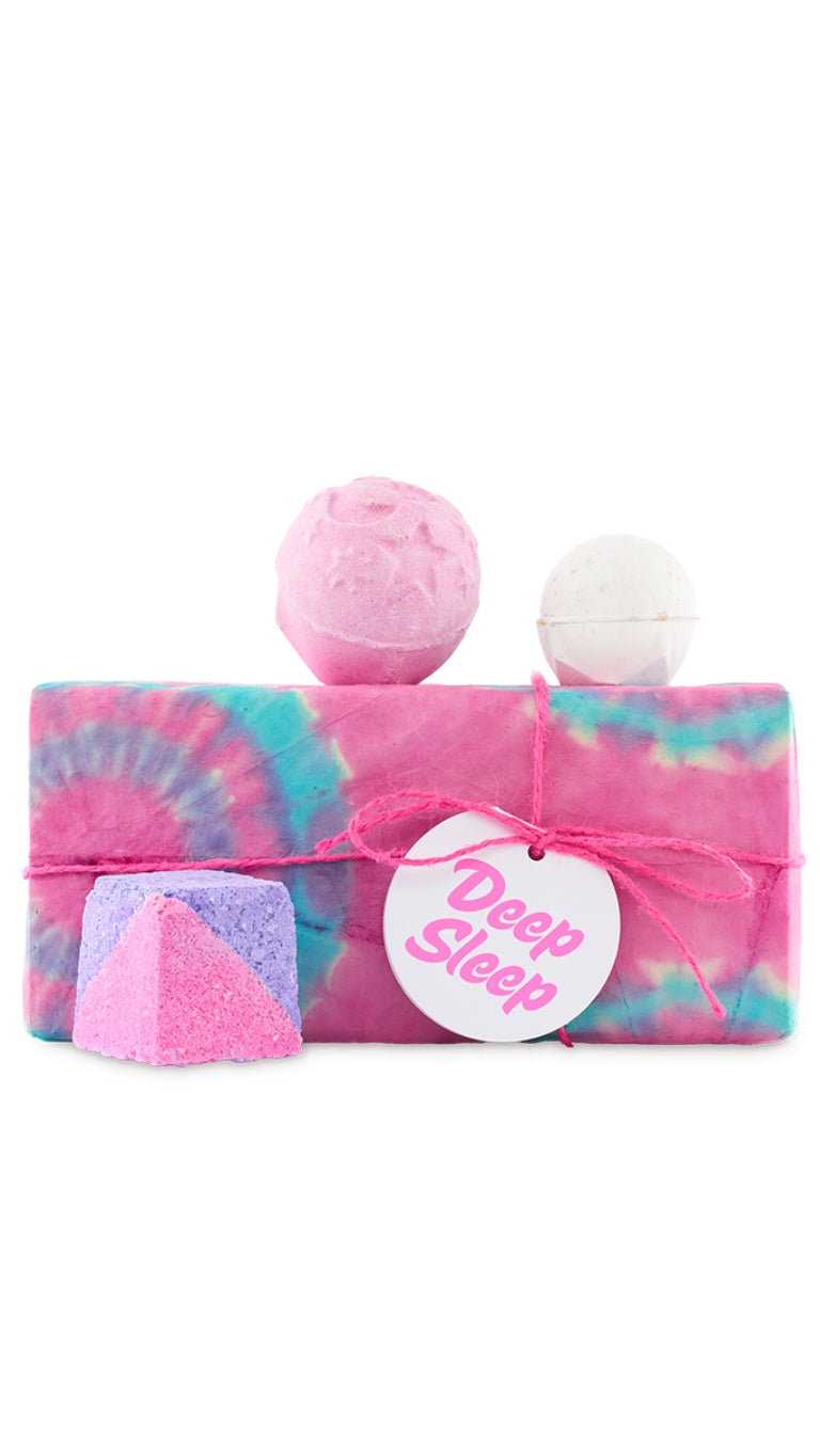 Deep Sleep gift featuring Twilight, Deep Sleep Cube and Butterball bath bombs displayed around a pink, white and blue tie-dyed wrapped gift box. 