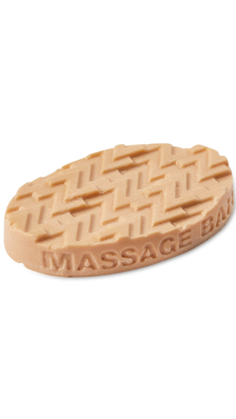 A clay coloured oval-shaped lush massage bar that smells like lavender.