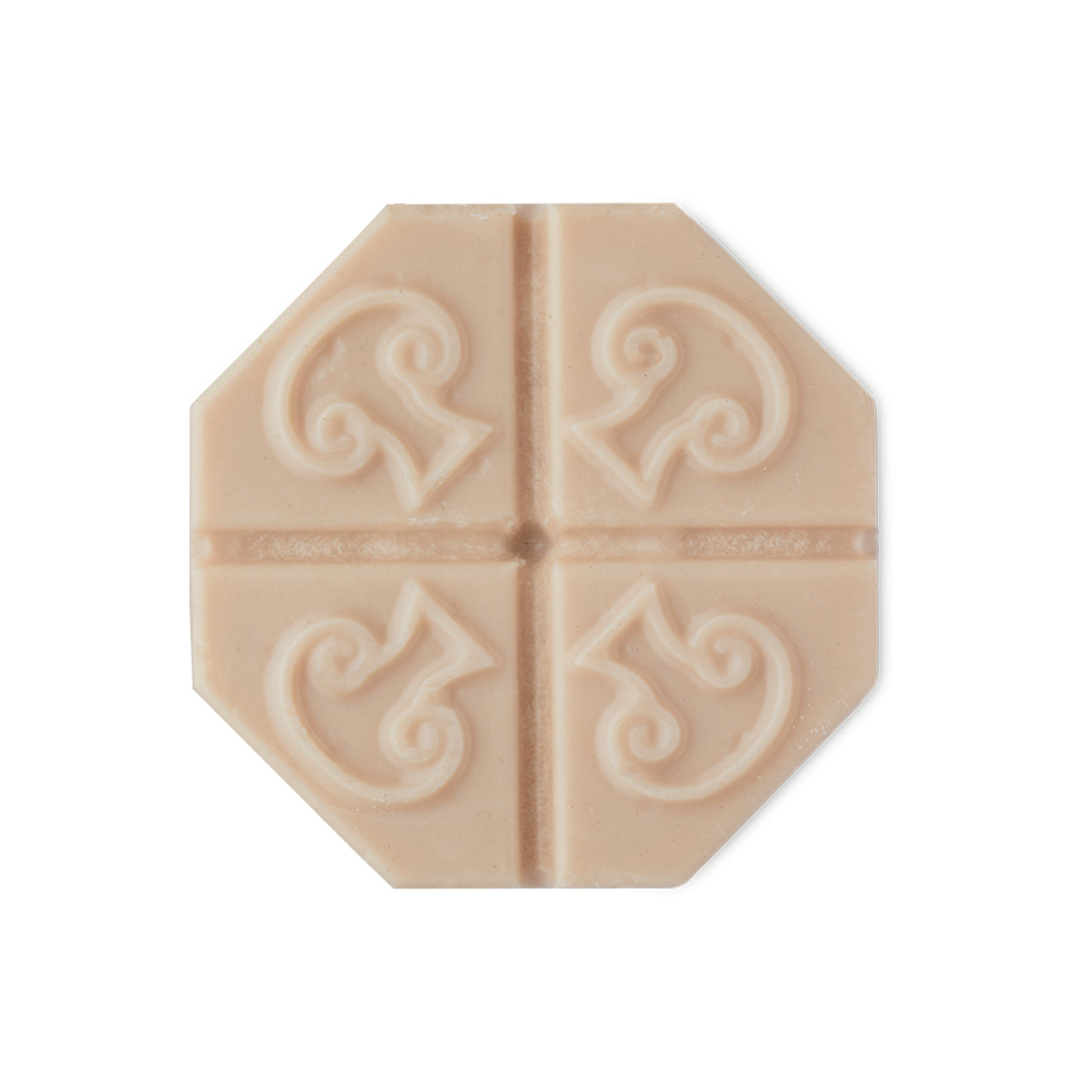 A cream hexagon-shaped solid facial serum with four mushrooms imprinted on it. 