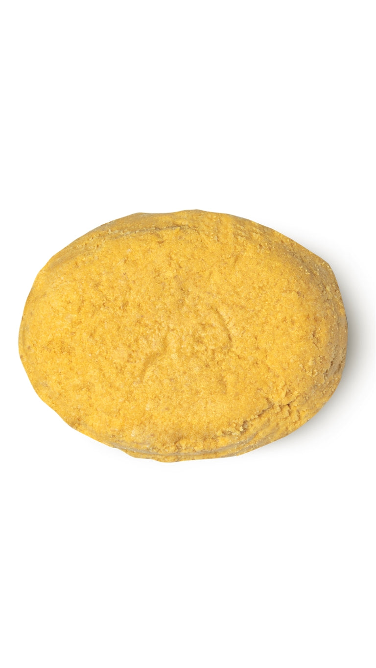 A yellow oval-shaped lush conditioner bar that smells like warm vanilla.