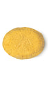 A yellow oval-shaped lush conditioner bar that smells like warm vanilla.