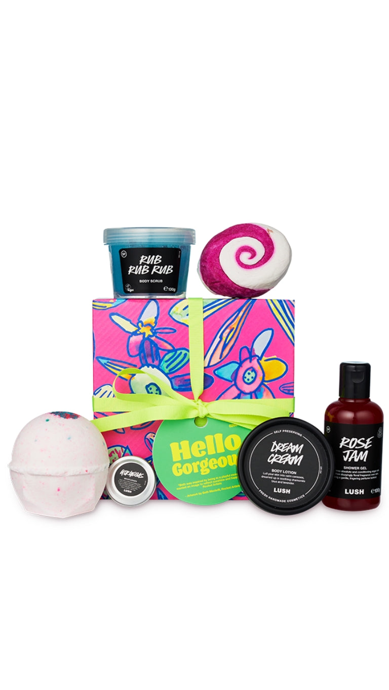 Hello Gorgeous Gift featuring a variety of shower, bath and body products displayed around a graphic patterned hat-box. 