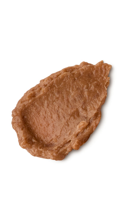 A brown tear-shaped swatch of a lush lip butter. 