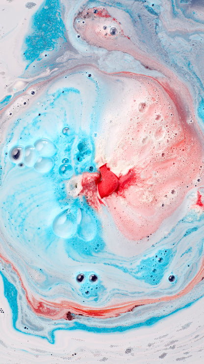 Jet Ski bath bomb creating blue, pink and white swirls of foam in the bath.