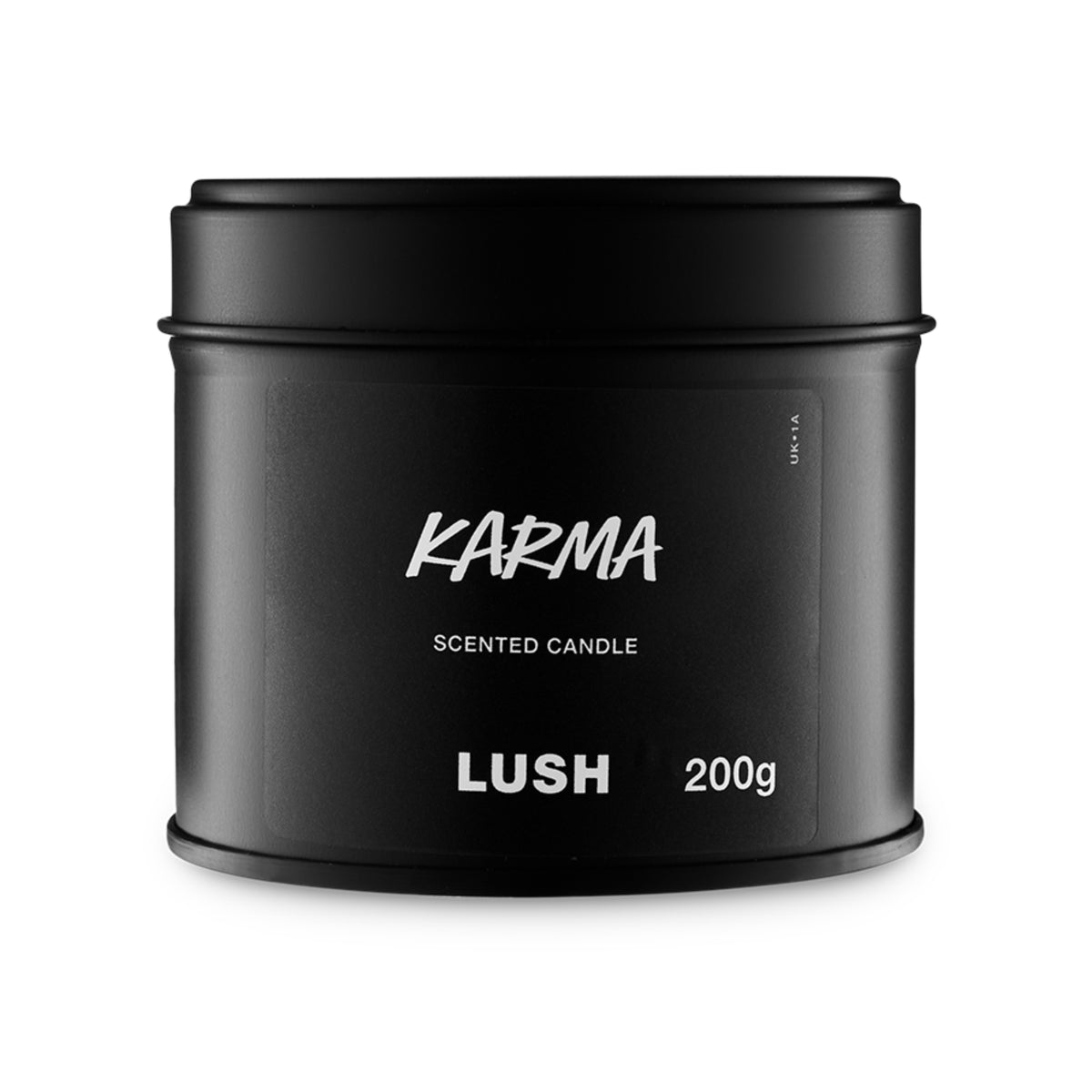 A short, wide cylindrical Lush candle container with the product name printed in white on the front.