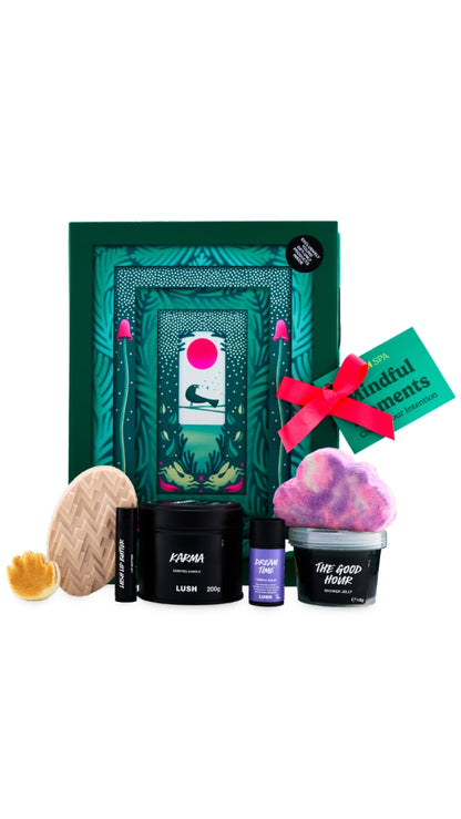 Mindful moments gift featuring a variety of lush all-year-round products displayed in front of a large gift box. 