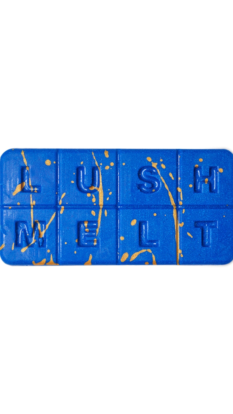 A dark blue and gold marbled rectangular-shaped bath melt that smells like florals. 