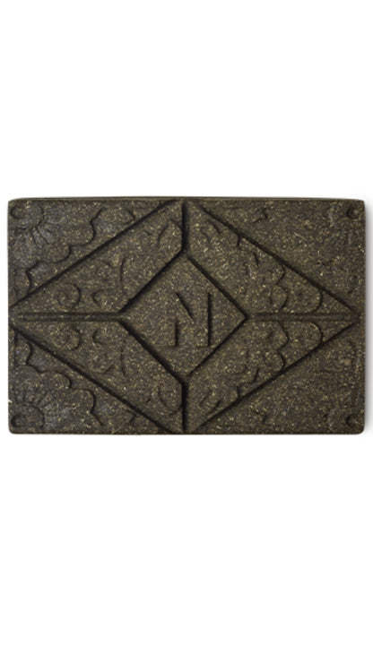 A brown rectangular block of lush henna hair dye. 