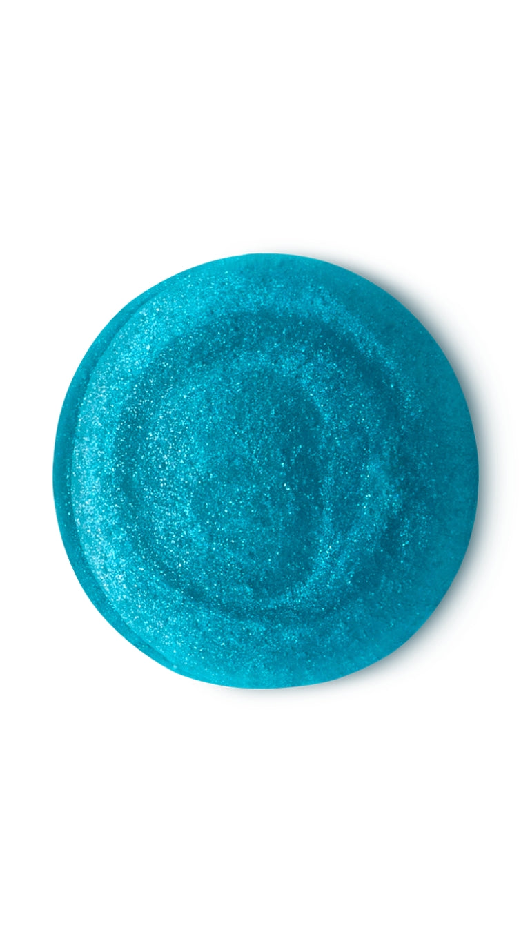A blue iridescent circular swatch of a lush shower gel. 