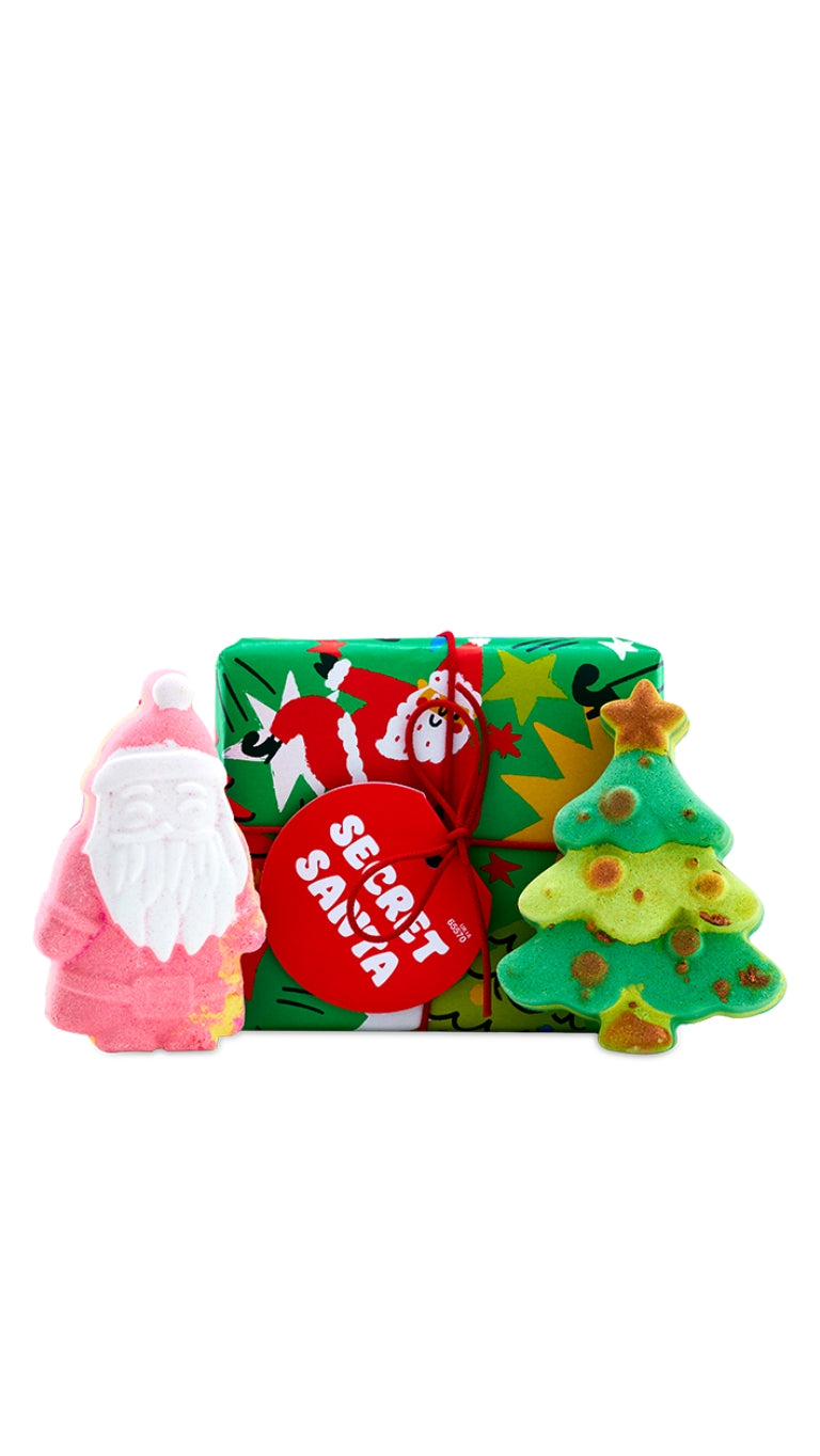 Secret Santa gift featuring Magical Santa and Christmas Tree bath bombs, displayed in front of a colourful graphic wrapped gift box. 