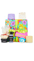 Serenity Gift featuring a variety of shower, bath and body products displayed around a large floral patterned wrapped gift box. 