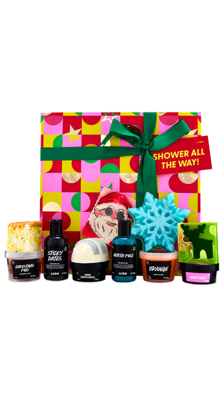 Shower All the Way gift featuring Christmas exclusive shower and body products, displayed in front of a large hat box. 