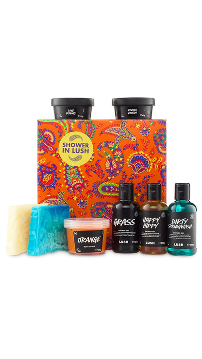 Shower in Lush Gift featuring a variety of shower-related products displayed around a large orange patterned hat box. 