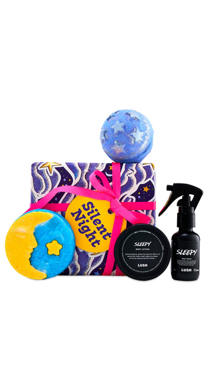Silent Night gift featuring Sleepy body spray and body lotion, festive bath products, displayed around a purple wrapped gift box. 