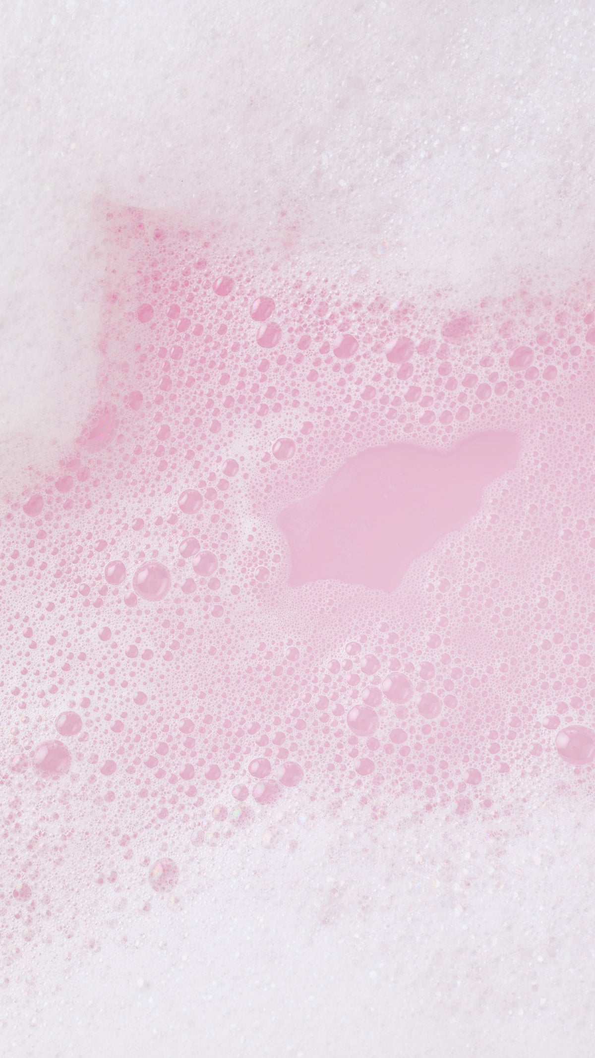 A heart-shaped patch of pink bathwater surrounded by white and pale pink Snow Fairy Fun bubbles.