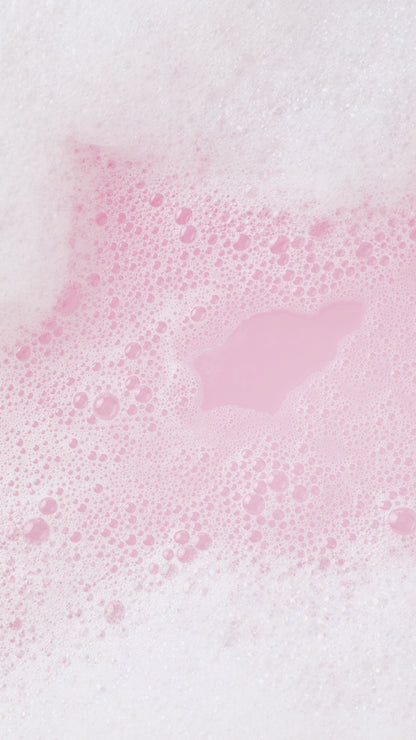 A heart-shaped patch of pink bathwater surrounded by white and pale pink Snow Fairy Fun bubbles.