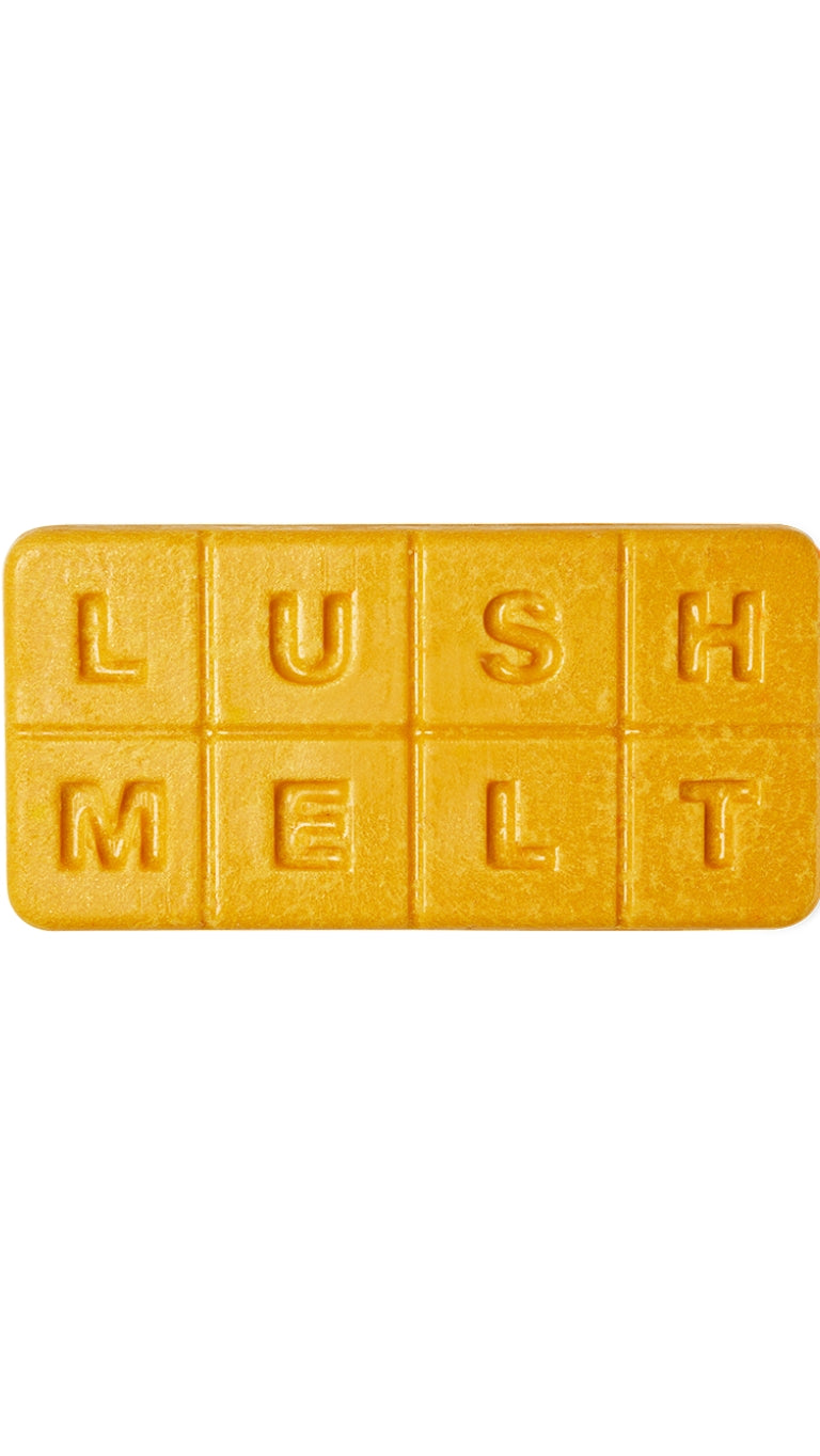 A golden-yellow rectangular-shaped bath melt with almond bits that smell like warm syrup. 