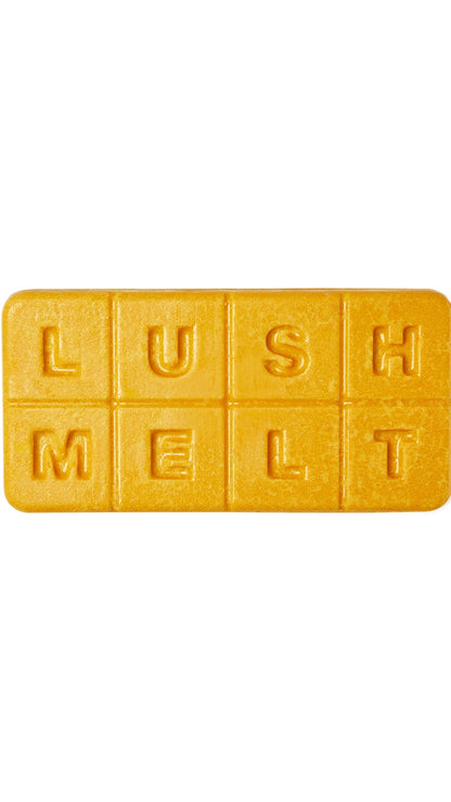 A golden-yellow rectangular-shaped bath melt with almond bits that smell like warm syrup. 