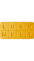 A golden-yellow rectangular-shaped bath melt with almond bits that smell like warm syrup. 