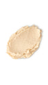 A cream oval-shaped swatch of a lush cream shampoo that smells like lemony creams. 