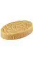 A cream oval-shaped lush massage bar that smells like toffee pudding. 