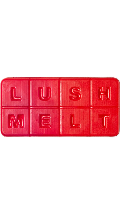 A red rectangular-shaped bath melt that smells like strawberries. 