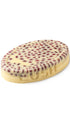 A cream oval-shaped lush massage bar with berries on the top 